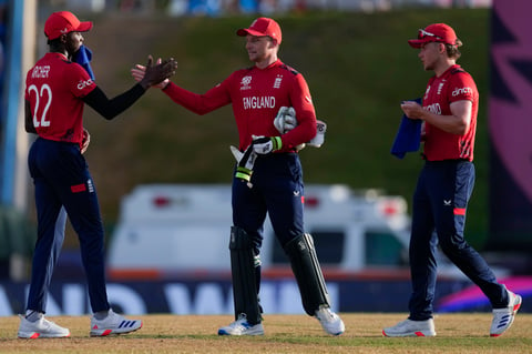 England's captain Jos Buttler, center, celebrates with Jofra Archer, left, and Sam Curran after winning an ICC Men's T20 World Cup cricket match against Namibia at Siv Vivian Richards Stadium in North Sound, Antigua and Barbuda, Saturday, June 15, 2024. (AP Photo/Ricardo Mazalan)


